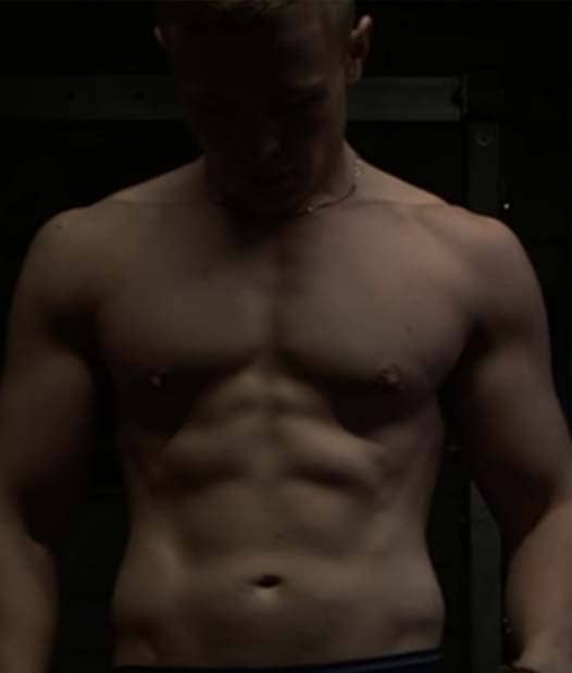 A shirtless picture of coach Cathal looking down
